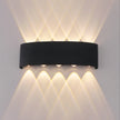 Black wall-mounted outdoor light fixture on a gray wall