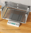 Metallic kitchen rack on a digital scale with a wooden surface background