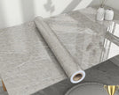 Roll of gray marble-patterned vinyl wrap on a table