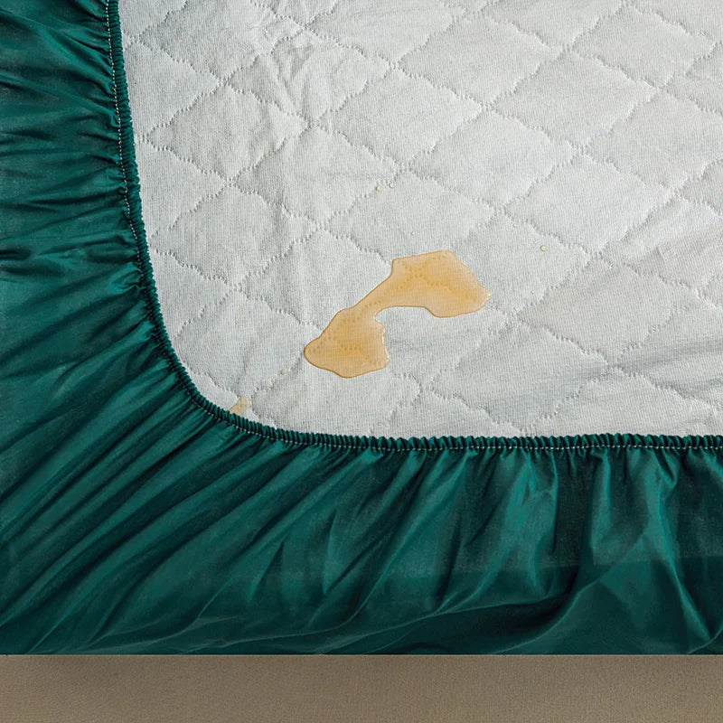 Teal fitted sheet with a stain on a mattress corner