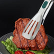 Grilled steak on a plate with a spatula piercing through it, against a black background.
