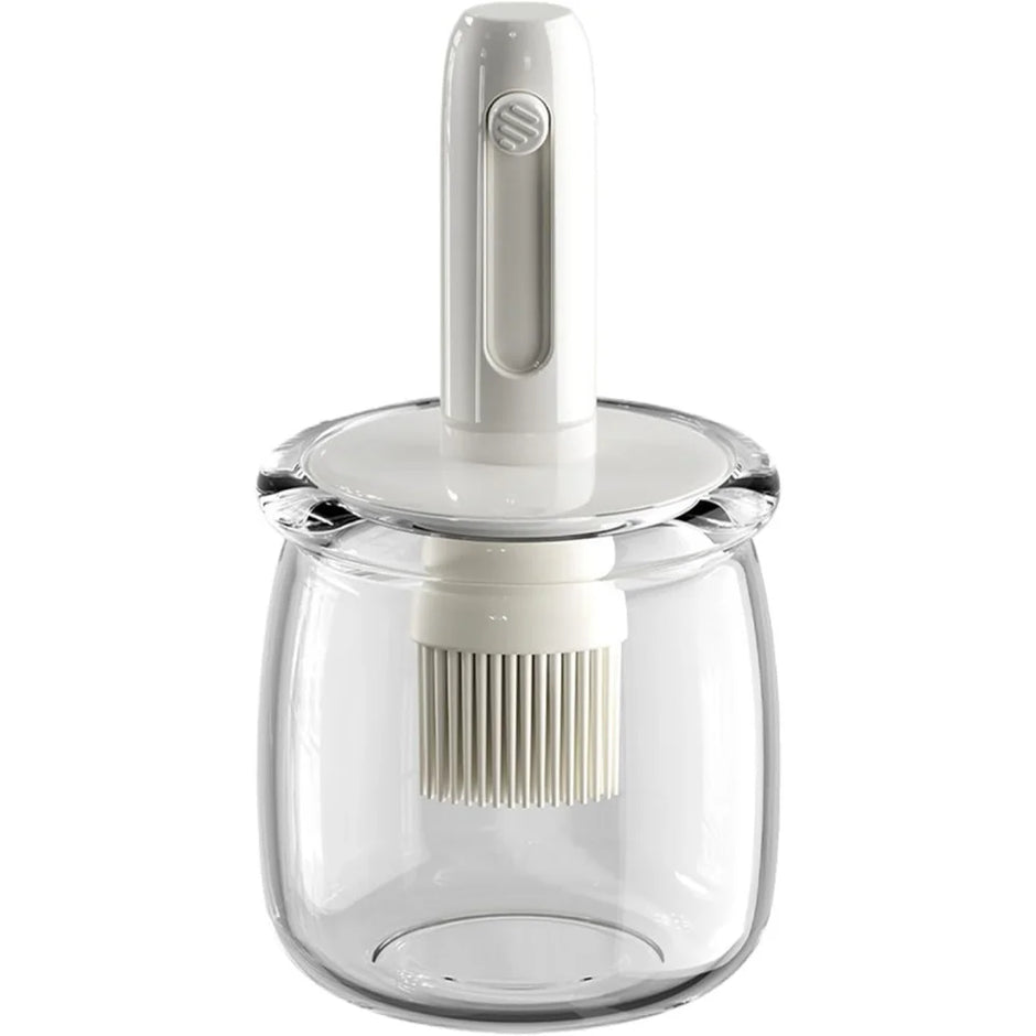 Clear glass jar with white lid and whisk attachment on a white background