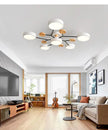 Modern living room with a chandelier, TV, and furniture.
