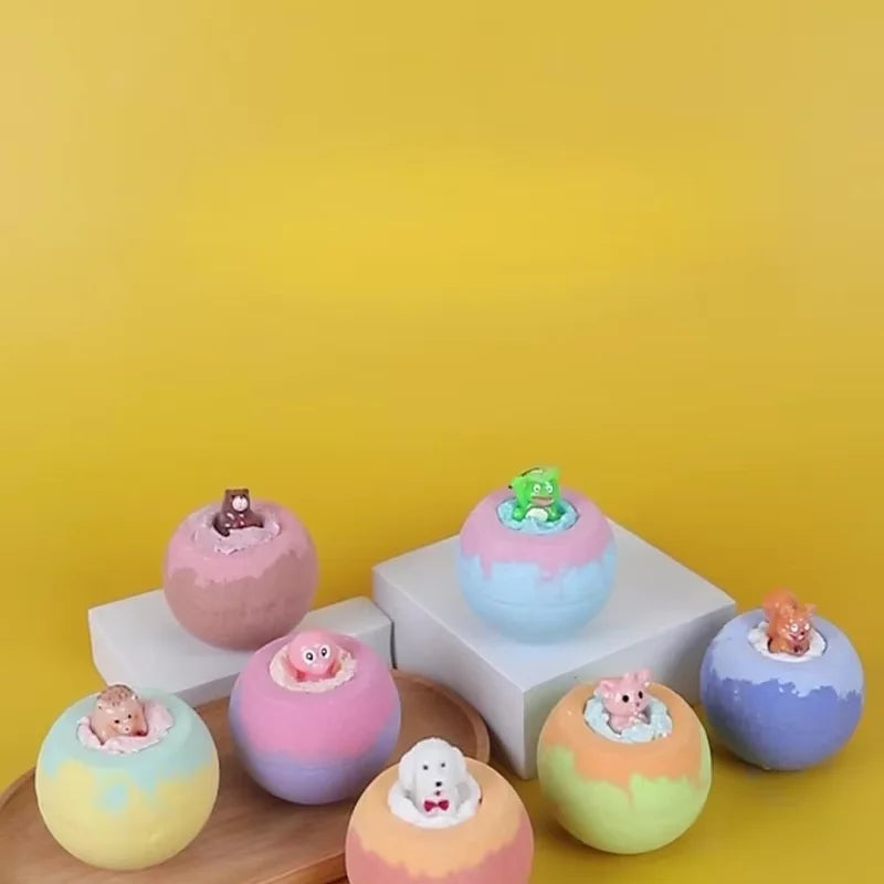 Colorful bath bombs with small figures on a yellow background