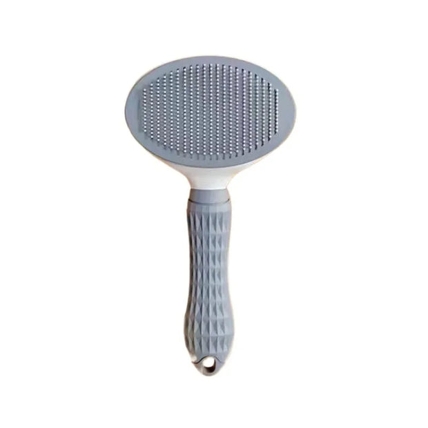 Pet grooming brush with gray bristle head and white handle on a white background