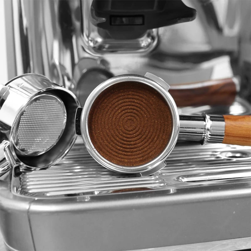 Close-up of an espresso filter with a coffee machine in the background