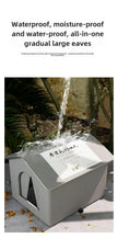 Outdoor water feature with a large eaves structure, surrounded by plants and stone wall.