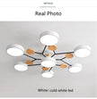 Modern ceiling light fixture with wooden accents on a plain background