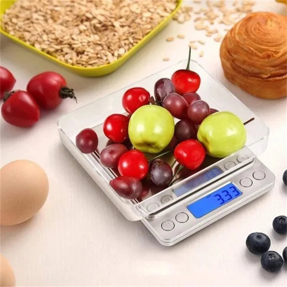 Digital kitchen scale with fruits on a light surface