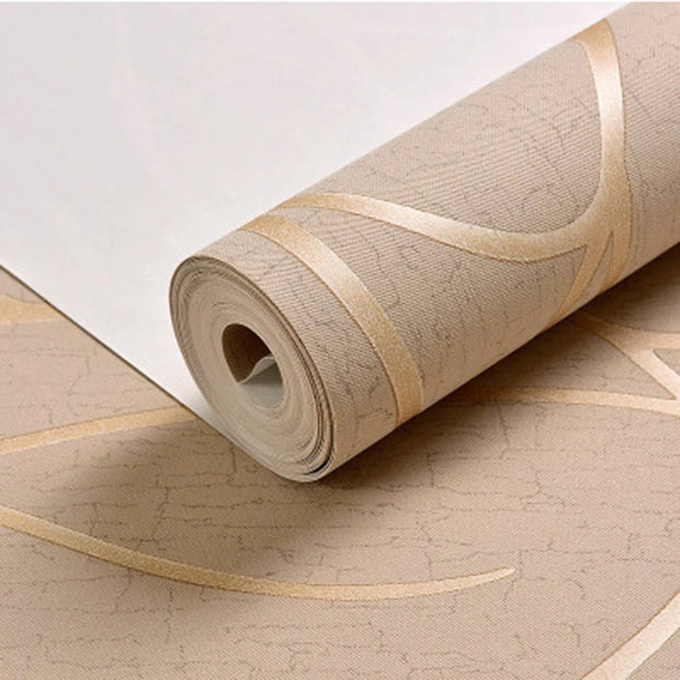 Roll of beige wallpaper with gold accents on a matching surface.
