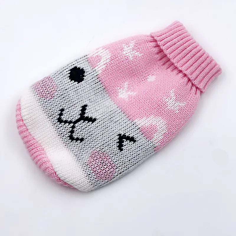 Knitted pet sweater with a cartoon face design on a white background