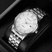 Silver wristwatch with white face on a black background
