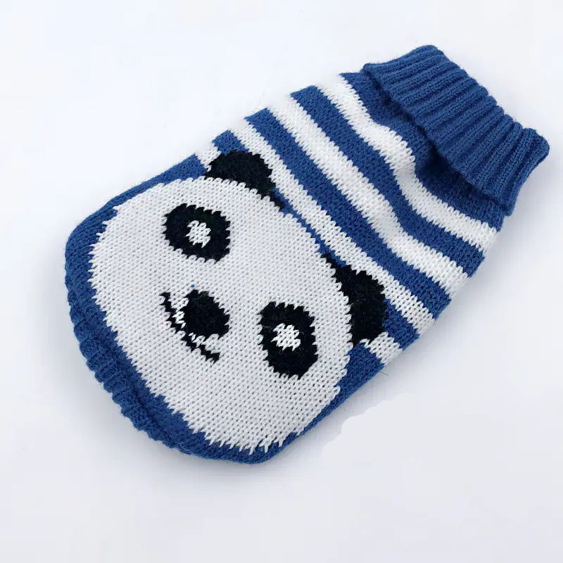 Knitted dog sweater with panda design on a white background